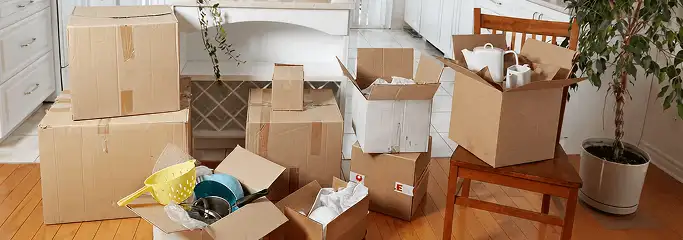 Packed moving boxes and household items in a kitchen before move-out or move-in cleaning, Mesa, AZ.